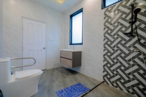 Modern bathroom with geometric tile design and accessible features