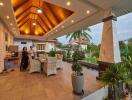 Spacious outdoor patio with dining area and greenery