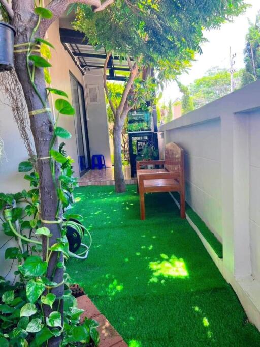 Outdoor relax area with artificial grass and seating