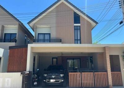 Front view of a modern two-story house with a car in the driveway