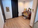 Spacious room with wooden flooring and a small desk area