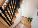 Modern wooden staircase with black railings