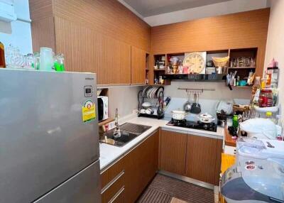 Modern kitchen with wooden cabinets and stainless steel appliances