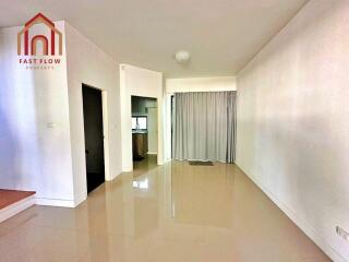 Spacious and minimalistic main living area with natural light and polished flooring