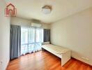 Simple bedroom with wooden floor, single bed, and large window with curtains