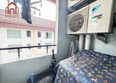 Small balcony with air conditioning units and laundry hanging