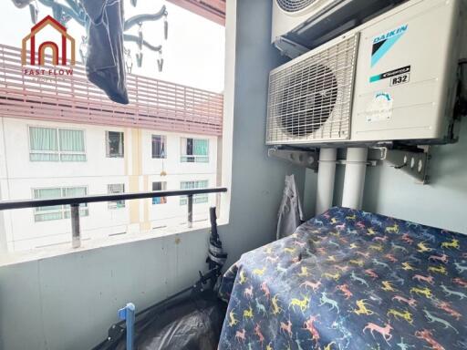 Small balcony with air conditioning units and laundry hanging