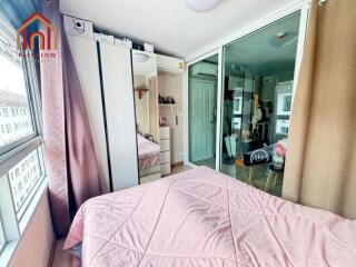 Cozy bedroom with mirrored wardrobe and pink bedspread