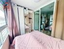 Cozy bedroom with mirrored wardrobe and pink bedspread