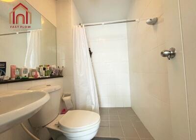 Bathroom with a shower, toilet, and countertop sink