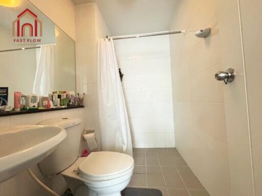 Bathroom with a shower, toilet, and countertop sink