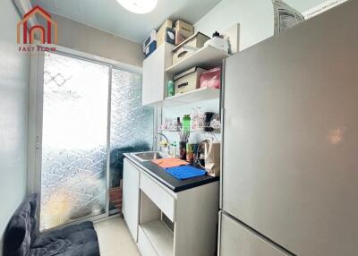 Compact kitchen with refrigerator and storage cabinets