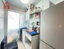 Compact kitchen with refrigerator and storage cabinets