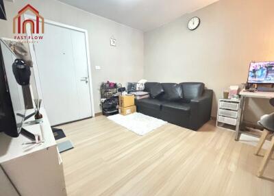 Living room with black sofa and TV