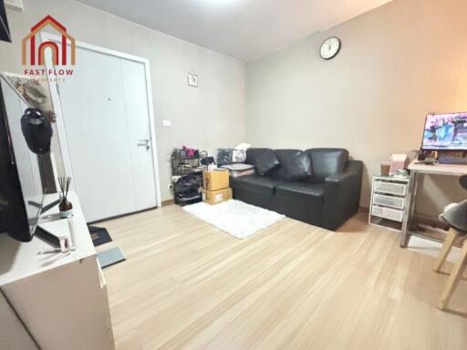 Living room with black sofa and TV