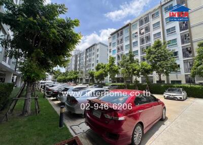 Apartment building exterior with parking area