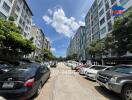 Residential apartment buildings with parking lot and cars