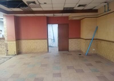 Empty room with red and yellow walls and a doorway