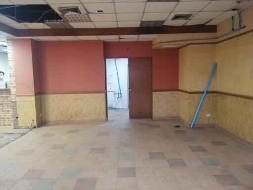 Empty room with red and yellow walls and a doorway