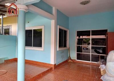 Outside view of a residential property with tiled floor and blue painted walls