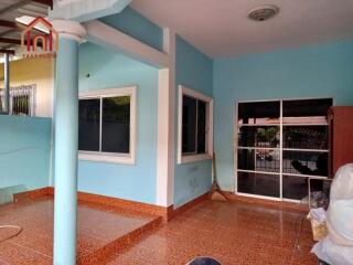 Outside view of a residential property with tiled floor and blue painted walls