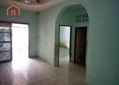 Empty room with tiled floor, archway, and doorways