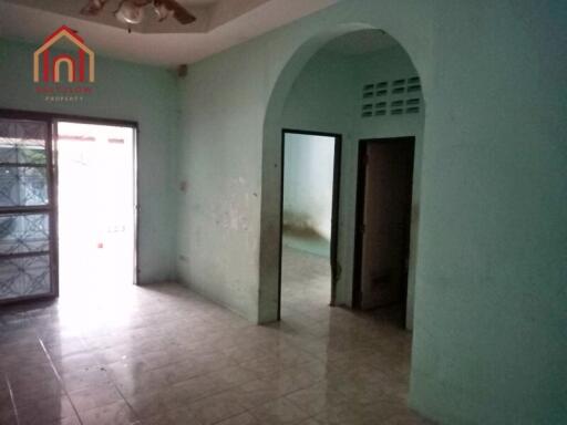 Empty room with tiled floor, archway, and doorways