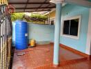 Outdoor area with water storage tank, tiled floor, and window