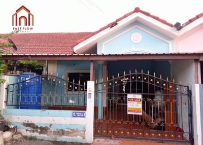 Front view of a house with a for sale sign