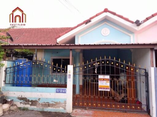 Front view of a house with a for sale sign