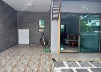 Covered outdoor area with bike and sliding door entrance