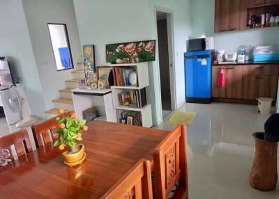 Kitchen with dining area and adjacent staircase