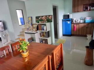 Kitchen with dining area and adjacent staircase