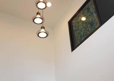 Modern ceiling light fixtures in a high ceiling living area