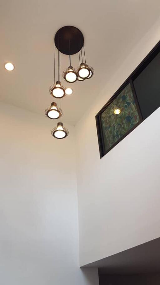 Modern ceiling light fixtures in a high ceiling living area