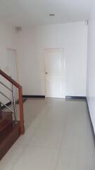 Spacious hallway with door and staircase