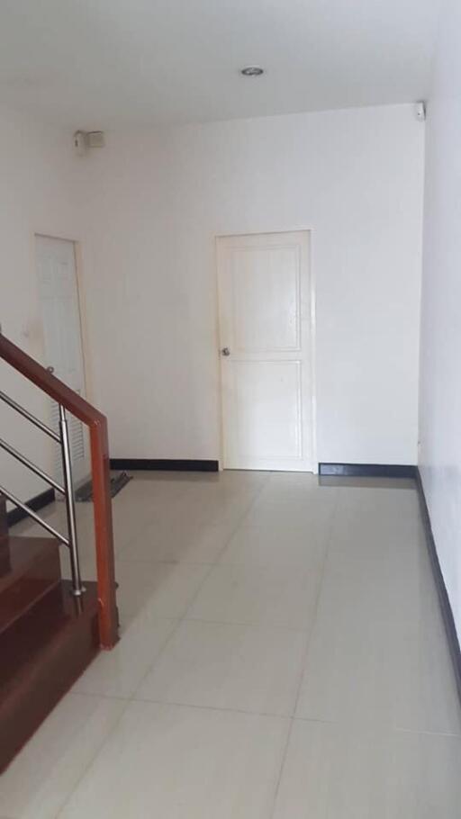 Spacious hallway with door and staircase