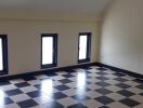 Room with checkered floor tiles and windows