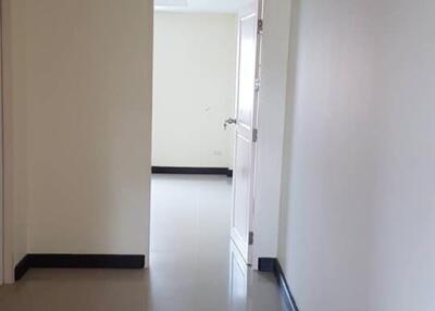 Empty hallway leading to a room