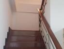 Staircase with wooden steps and metal railing