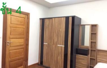 Bedroom with wooden wardrobe and door