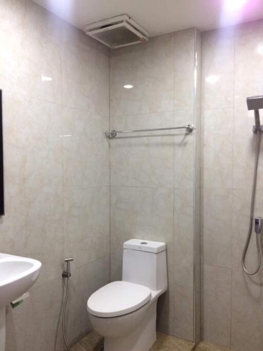 Modern bathroom with toilet, sink, and shower