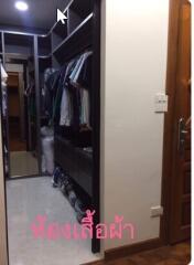 well-organized walk-in closet with hanging clothes and shelves