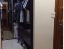 well-organized walk-in closet with hanging clothes and shelves