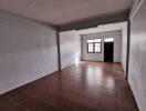 Spacious empty living area with tiled floor