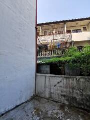 Exterior view of property with a concrete patio and balcony