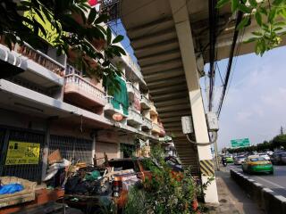 Exterior view of a multi-story building next to a busy road