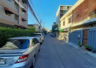 Street view with parked cars and adjacent buildings