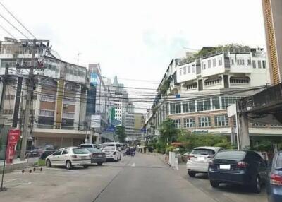 View of a street with buildings and parked cars