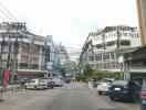 View of a street with buildings and parked cars